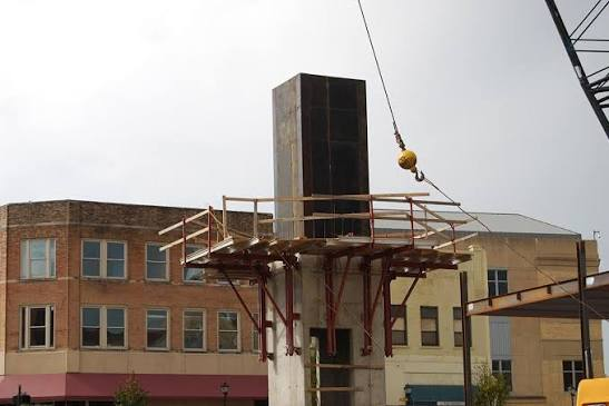Large flying table deck section lifted by crane between floors